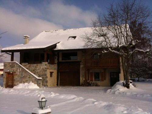 a house covered in snow with a lamp in front of it at Spacious Farmhouse Apartment, by Lake & Mountains in Larringes
