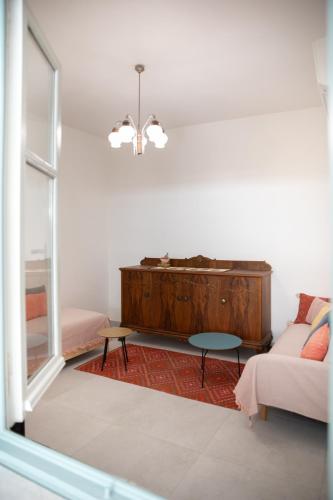 a living room with a couch and a table at Mirtilo - Local Style, 1 Min from Main Beach in Kardamaina