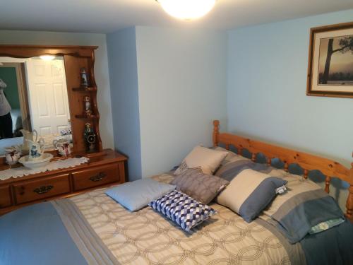 a bedroom with a bed with pillows on it at Dorman's Manor in Bonavista