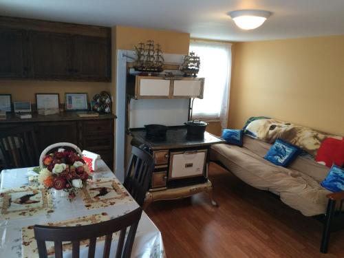 a living room with a table and a couch at Dorman's Manor in Bonavista