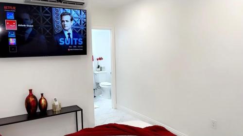 a living room with a flat screen tv on the wall at Cozy Studio…5 min away from LAS Airport. “ in Las Vegas