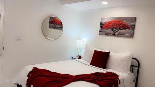 a bedroom with a large bed with a red tree at Cozy Studio…5 min away from LAS Airport. “ in Las Vegas