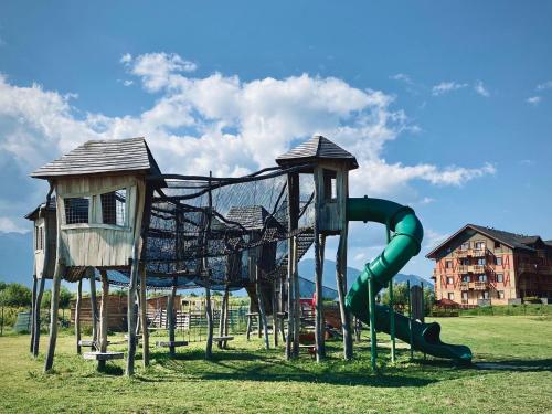 a playground with a slide and a play structure at Holiday Resort Tatry in Veľká Lomnica