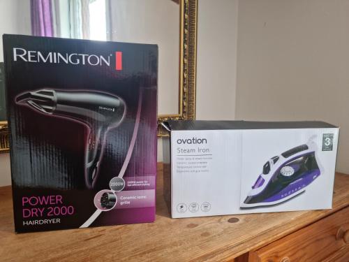 a box on a counter next to a power dry router at 4 Bedroom Spacious House Perfect for Family & Business Short Long-Term Stays Easy Access to Manchester, Oldham, Bury in Rochdale