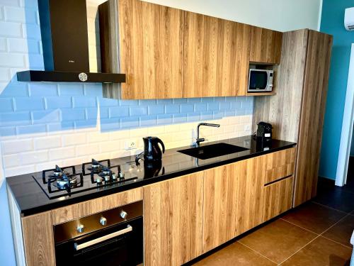 a kitchen with a sink and a counter top at TorreNormanna Prestige House near Cefalù in Mandra Capreria