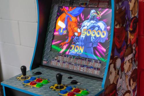 a video game machine with a summon game on it at Thematic House with Private pool and Game Room in Loughman
