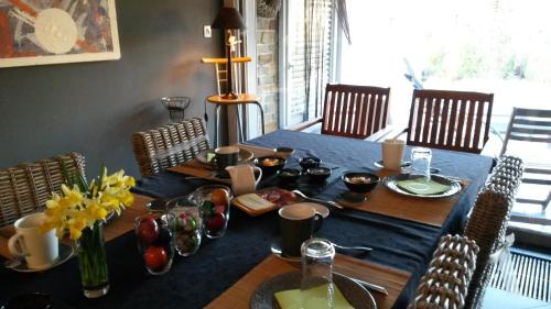 a dining room table with a blue table cloth at A L'inattendue in Bertrix