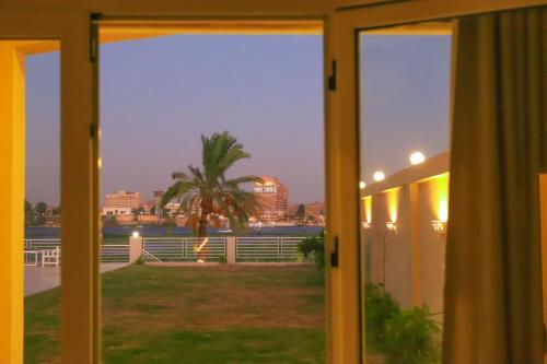 a view from the window of a house at Royal Nile Villas - Pool View Apartment 2 in Luxor