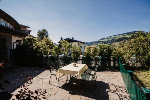 a table and chairs on a patio with a fence at Alpina Wagrain in Wagrain