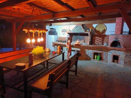 a kitchen with a table and a brick oven at Mavridis House in Eleftheroúpolis