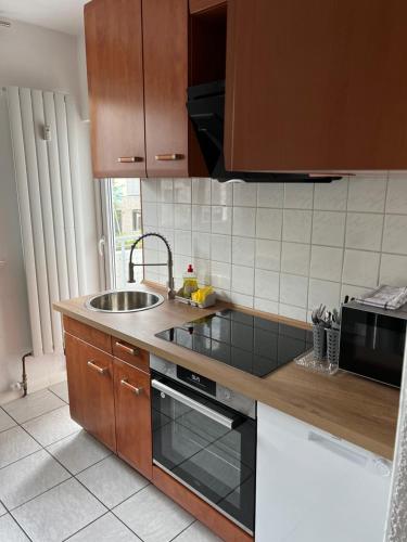 a kitchen with a sink and a stove top oven at Esslingen am Neckar Weilstr.47 in Esslingen