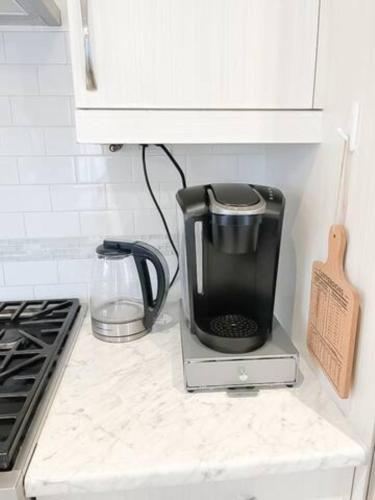 a coffee maker sitting on a counter in a kitchen at Inspired Stay close to Niagara *4B & 2King Beds* in Thorold