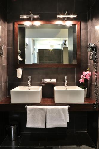 a bathroom with two sinks and a large mirror at Best Western Cinemusic Hotel in Rome