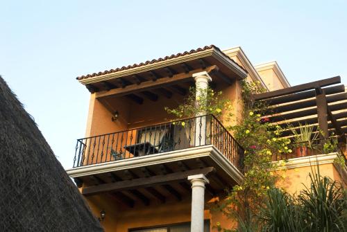 a building with a balcony on the side of it at Hotel Lunata - 5th Avenue in Playa del Carmen