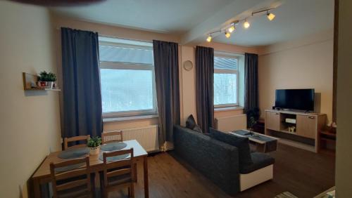 a living room with a couch and a table at Hotel Slávie in Trhová Kamenice