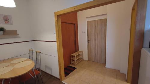 a room with a table and a wooden door at Hotel Slávie in Trhová Kamenice