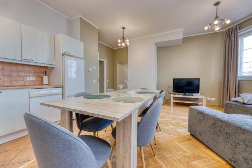 a kitchen and a dining room with a table and chairs at Historic Residence Apartments at Old Town in Tallinn