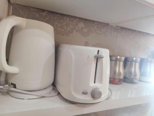 a white appliance sitting on a kitchen counter at 1 bedroom apartment in Neepsend