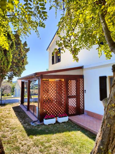 a house with a wooden door and some flowers at La Casa di Vandina in Senigallia