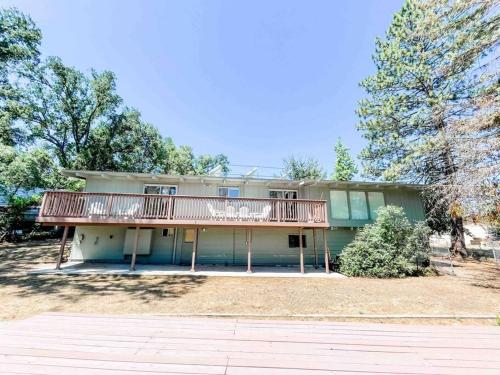 a large house with a deck on the side of it at Retreat Home Near Yosemite and Bass Lake! in Oakhurst