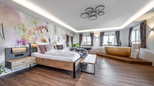 a bedroom with a large bed and a bath tub at Der Weberhof/Pension Willibald in Bad Tölz