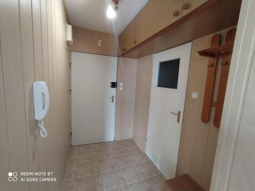 a bathroom with a toilet and a urinal and a door at Kawalerka na Ślichowicach in Kielce