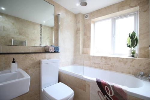 a bathroom with a toilet and a tub and a sink at Pet Friendly, Lake View, Parking, Golf Nearby in Bowness-on-Windermere