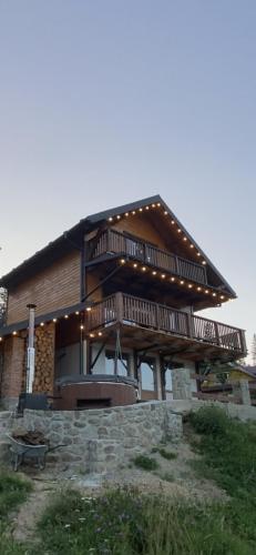a large wooden house with lights on it at Бриндуш in Tatariv