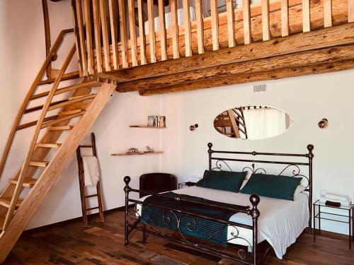 a bedroom with a bed and a wooden staircase at B&B FANCHETTI 1938 in Sondrio