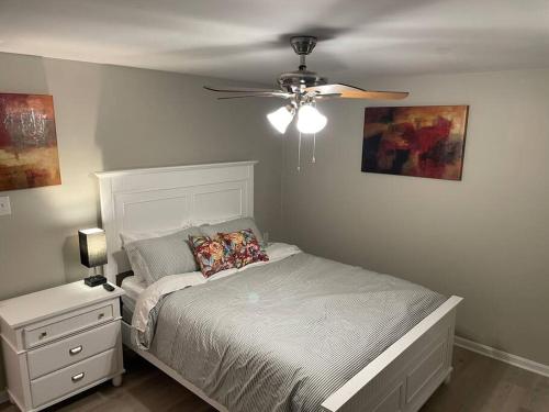 a bedroom with a bed and a ceiling fan at Spacious 3 Bedroom Home in Martinsburg WV. in Martinsburg