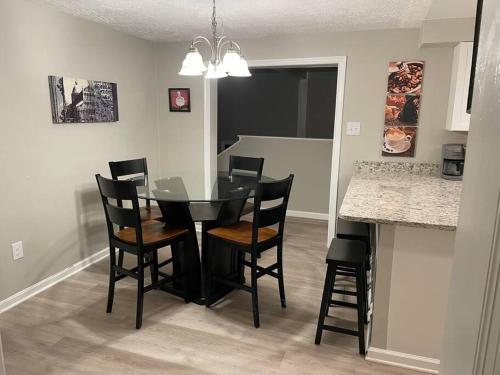 a dining room with a black table and chairs at Spacious 3 Bedroom Home in Martinsburg WV. in Martinsburg