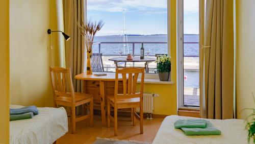 a dining room with a table and a view of the ocean at Viinistu Art Hotel in Viinistu