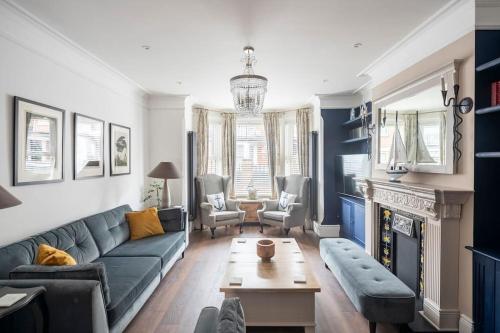 a living room with a couch and a table at Beautiful Spacious Beach Home Newly Renovated in Felixstowe