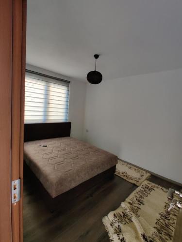 a bedroom with a bed in the corner of a room at 1971 apartments in Gusinje