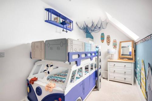 a childs bedroom with a blue and white bunk bed at Beautiful Spacious Beach Home Newly Renovated in Felixstowe