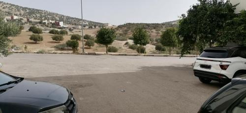 an empty parking lot with a white truck parked at Appartement Fès in Fez