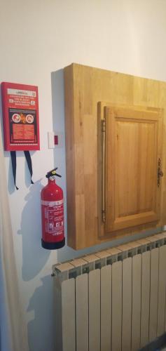 a kitchen with a fire hydrant and wooden cabinets at La maison sous le Château in Tallard