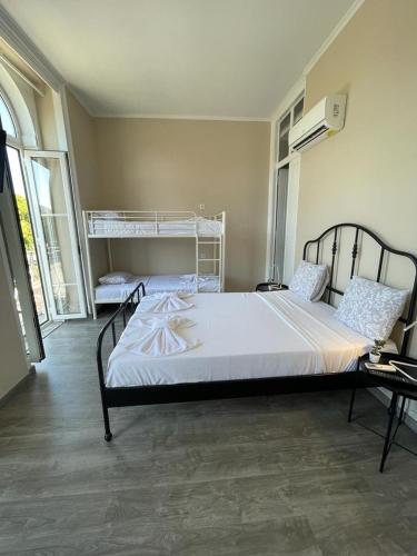 a bedroom with a large bed with white sheets at Suites DP Setúbal in Setúbal