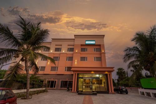 un bâtiment d'hôtel avec un panneau en haut dans l'établissement Palette - Coastal Grand Hotels & Resorts, OMR, à Chennai