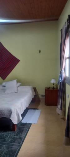a bedroom with a bed and a window at El cerrito in Cerrillos