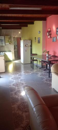 a living room with a table and a refrigerator at El cerrito in Cerrillos