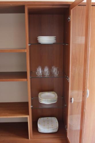 a cupboard with plates and dishes in it at Appartamento a due passi da Mantova in Curtatone