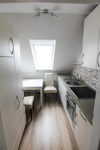 a small kitchen with a sink and a window at Appartement in Pattensen in Pattensen