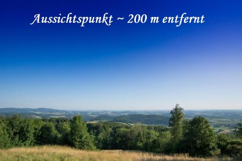 a view of a hill with trees in the distance at Helle FeWo am Waldrand - mit Balkon, Pool & Sauna in Freyung