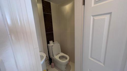 a bathroom with a toilet in a small room at Cleopatra sahile 50 metre in Alanya