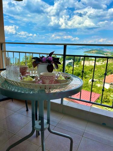 a table with a plate of food on a balcony at Villa Chingo in Ohrid