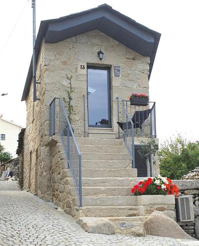a small stone building with stairs and a door at Casa Fina in São Pedro do Sul