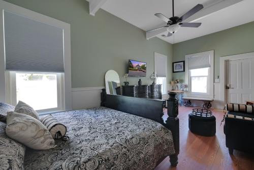 a bedroom with a bed and a ceiling fan at Spacious Downtown Jackson Retreat- Historic Hangout in Jackson