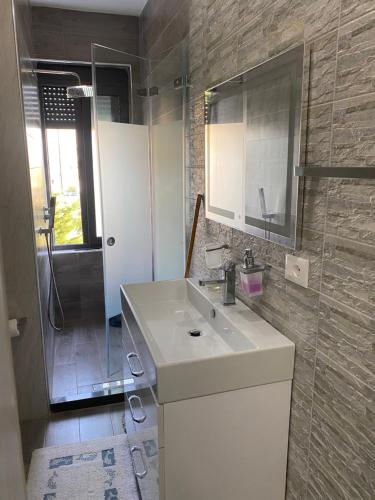 a bathroom with a white sink and a shower at Apartment in Golem