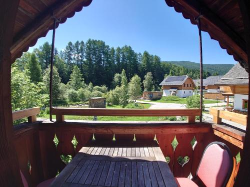 a porch with a bench and a view of a yard at Alm Chalet Grosseck in Mariapfarr